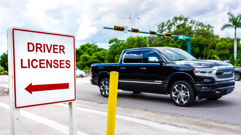 Truck driving by driver license sign