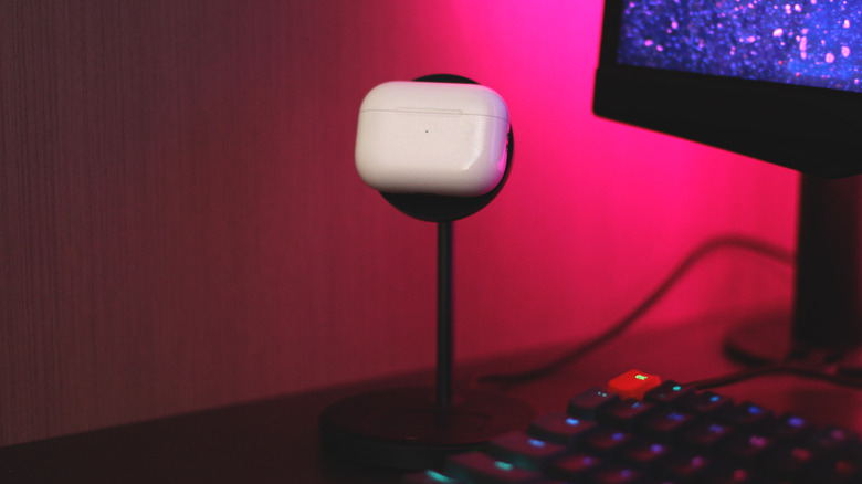 AirPods magnetically charging on a wireless charging stand