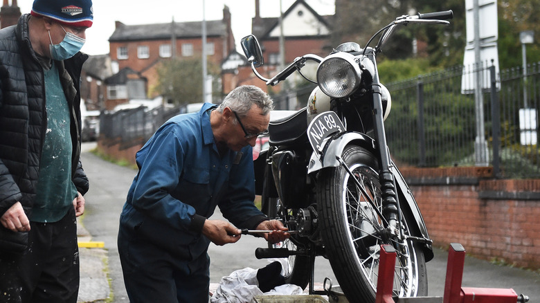 Man working on motorcycle engine