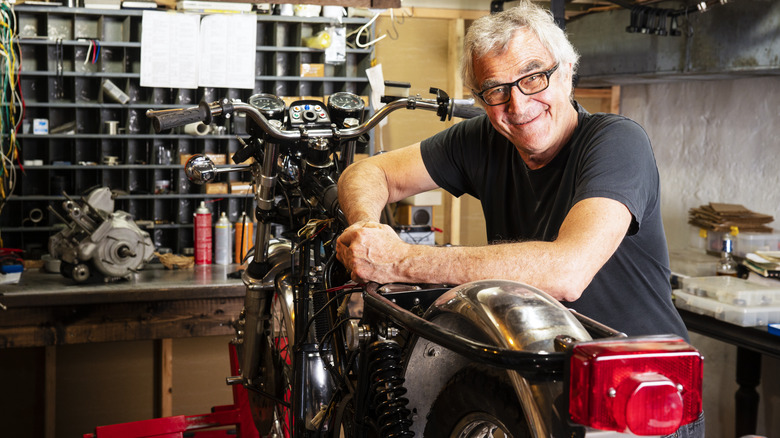 Mechanic working on motorcycle engine