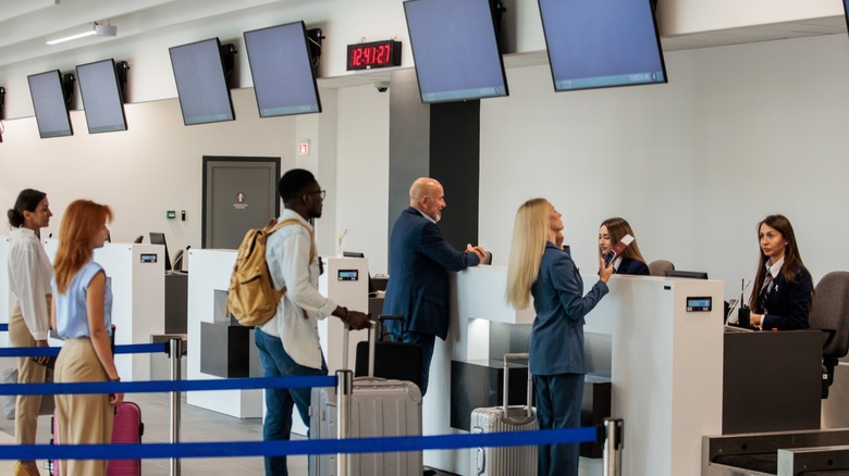 Travelers at the airport trying to check in