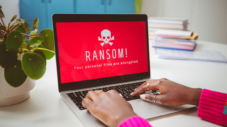 Woman using computer infected with ransomware