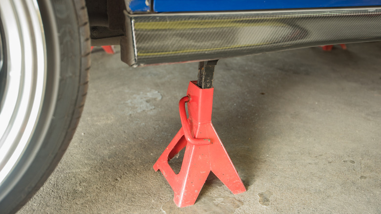 red jack stand under vehicle