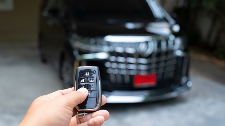 Buyer holding the key of a used car