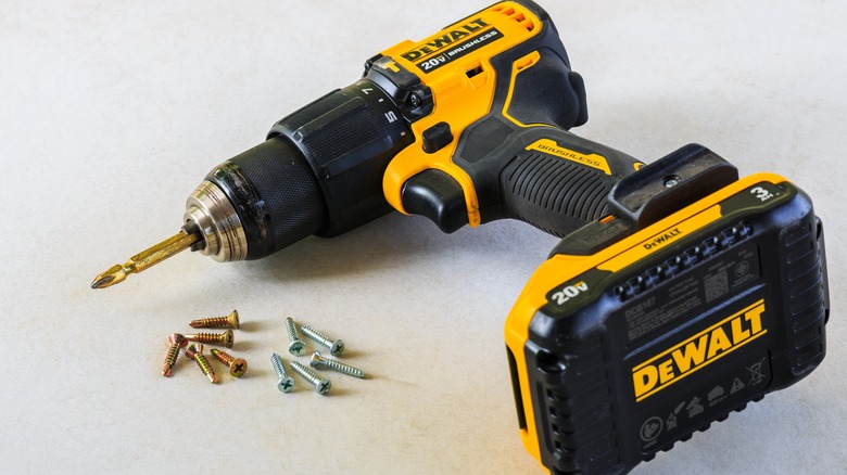 A battery-powered DeWalt drill on its side