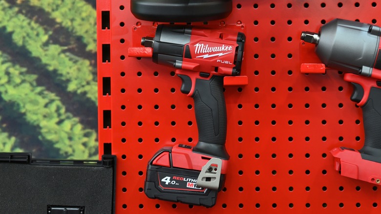 A Milwaukee drill on a board equipped with a Milwaukee battery.