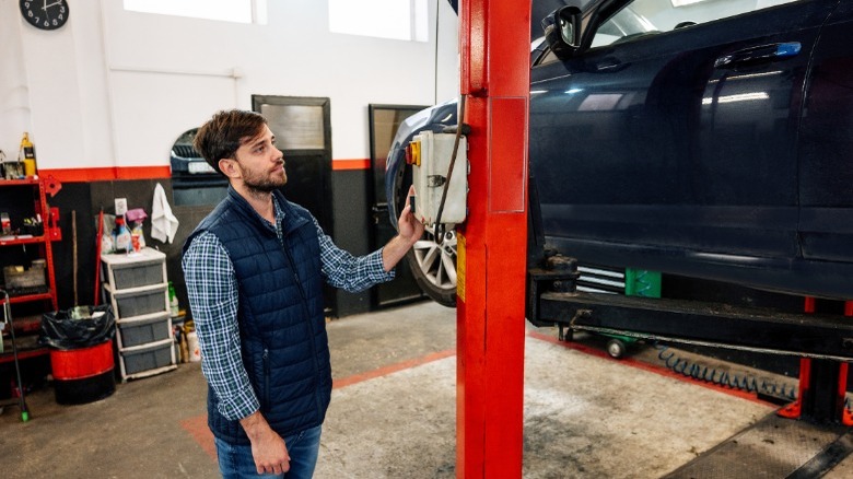 person operating car lift