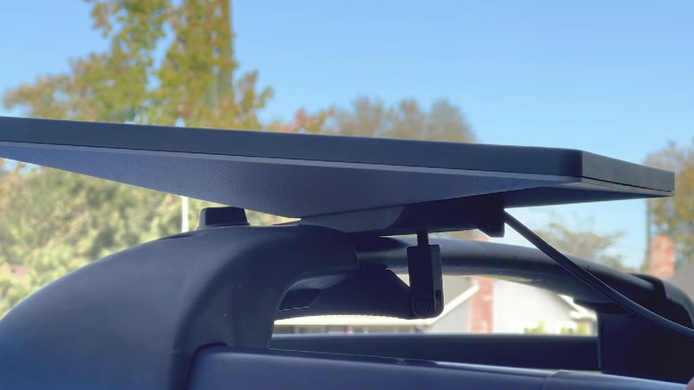 A Starlink dish mounted to a car rack using an official Starlink dish car mount