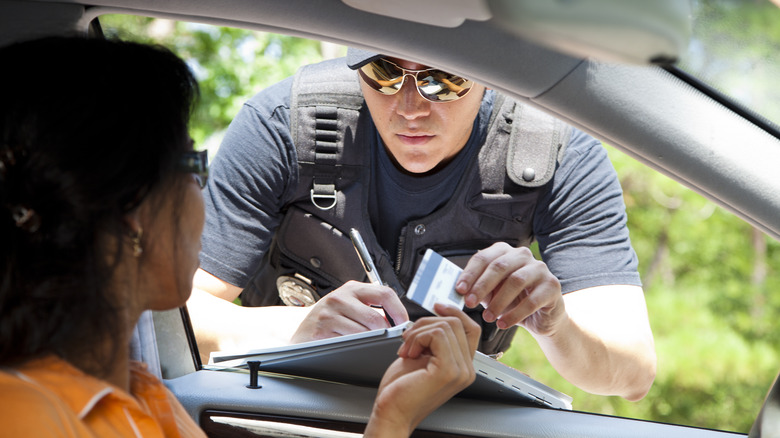 Cop writing speeding ticket