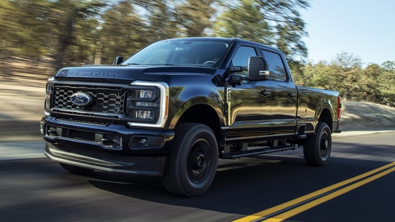 Black Ford Super Duty truck driving