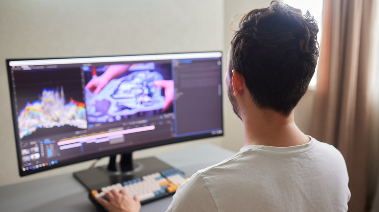 Man using an external monitor and keyboard