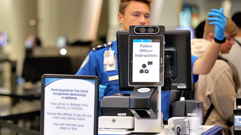 TSA officer directing passengers through line