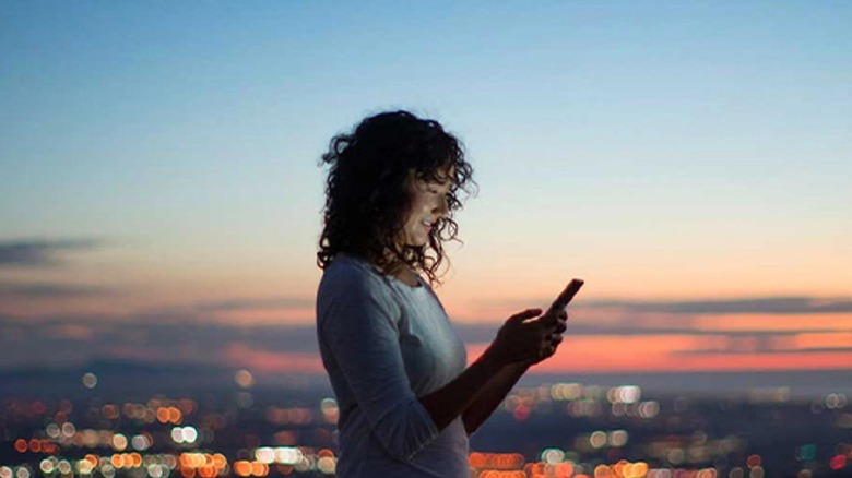 Woman using phone while outdoors