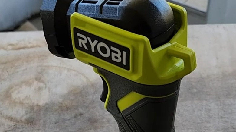 A Ryobi flashlight on a table.