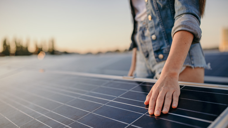 Person touching solar panels