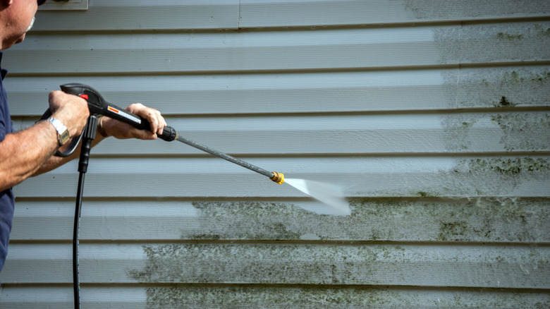 Man cleaning with power washer