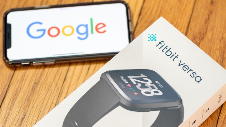 Fitbit Versa box beside smartphone