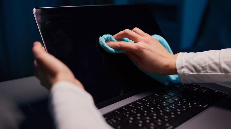 Cleaning laptop screen with a microfiber cloth