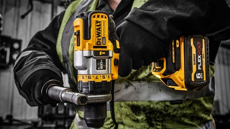 A person using a Flexvolt Advantage 20V DeWalt drill.