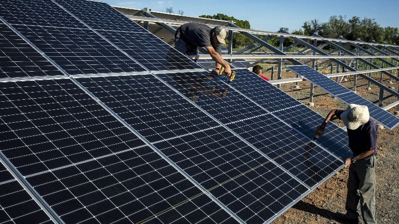 workers building a solar farm