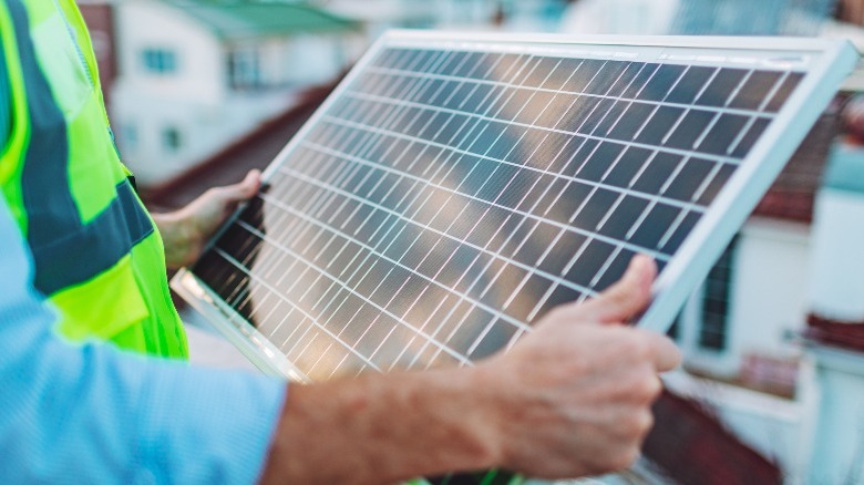 engineer inspecting solar panel