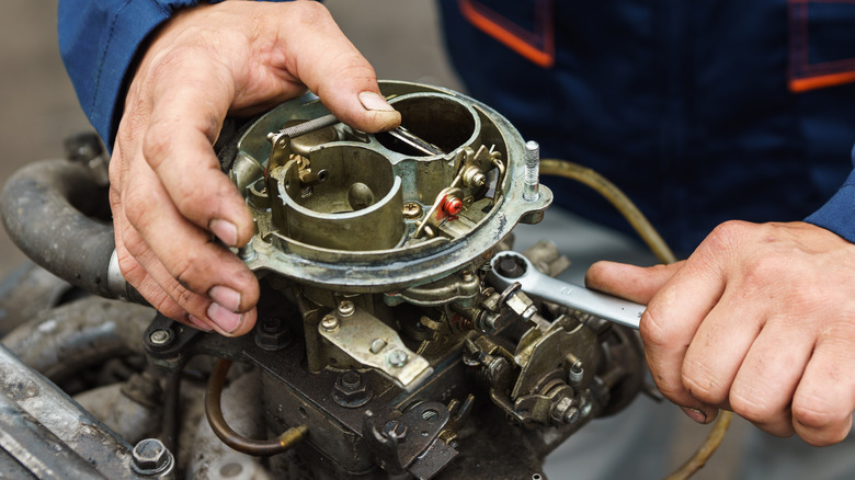 Mechanic fixing carburetor