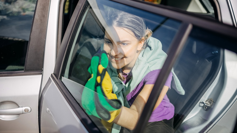 Woman wiping car's window