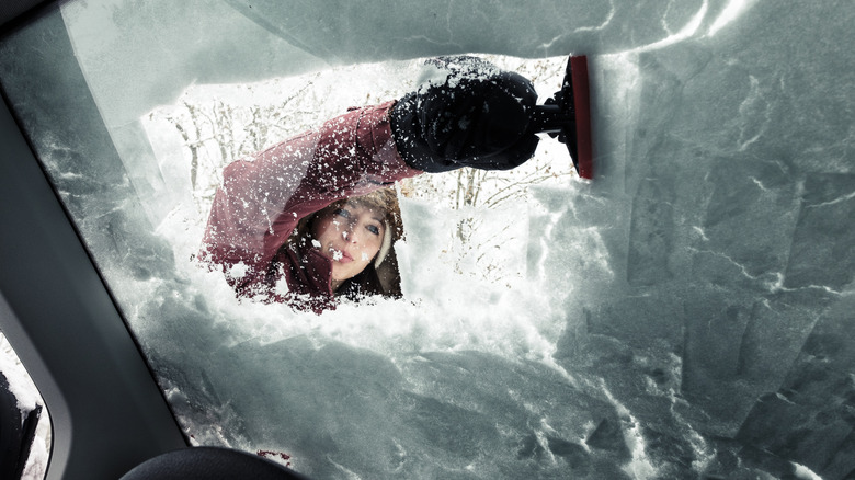 Woman Scraping Ice Off Windshield