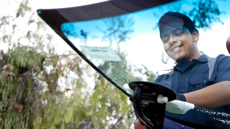 Man Replacing A Windshield