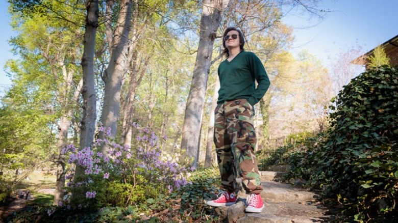 Person standing on path in greenery