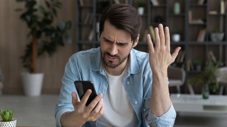 Man frustrated with smartphone