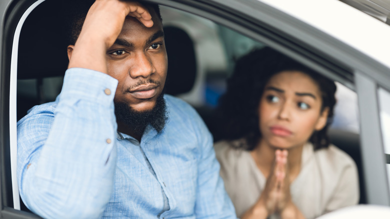 Couple considering to buy a new car