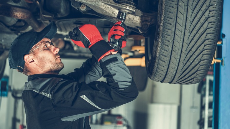 Mechanic working on suspension