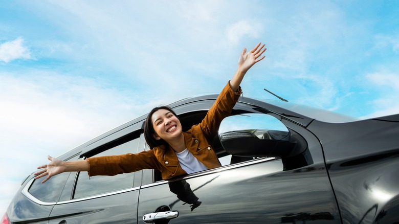 Person waving out of car window