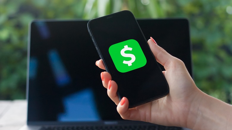 Cash App logo on black phone screen