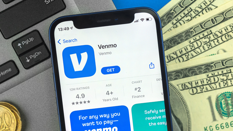 Venmo app on money and laptop