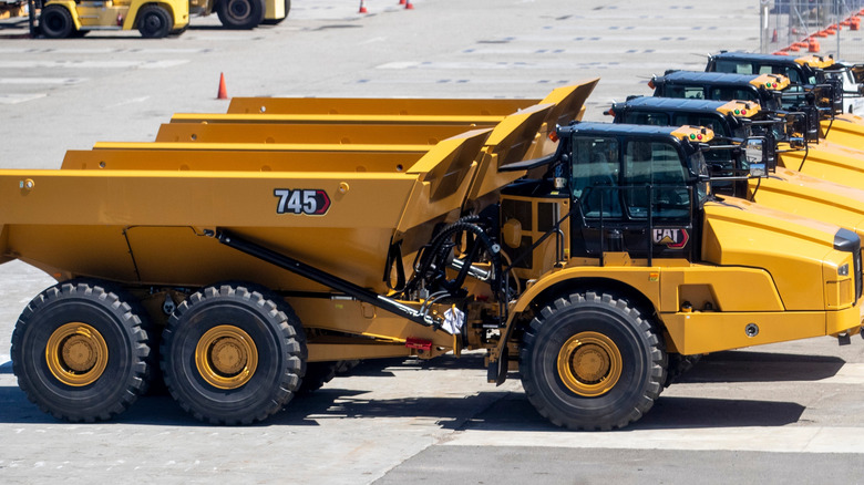 line of Caterpillar dump trucks