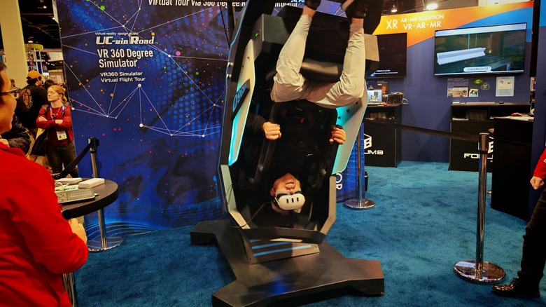 A man upside down on the VR360 machine