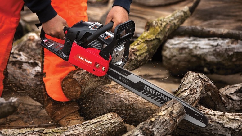 Man using Craftsman chainsaw