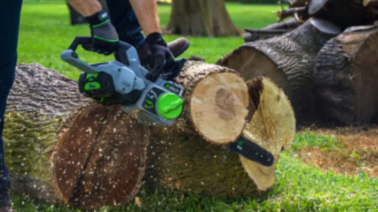 Man cutting with EGO chainsaw