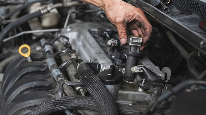 mechanic checking a vehicle's ignition