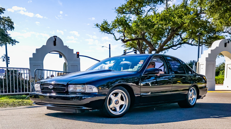 A 1996 Impala SS in black, sunny day, front 3/4 view