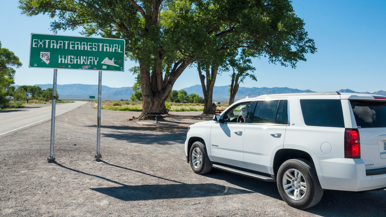 White Chevy Tahoe on side of highway