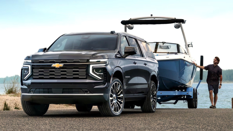 Man securing boat to his Chevy Suburban