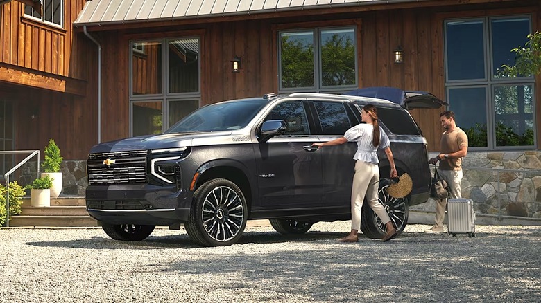 Couple loading up Chevy Tahoe for road trip