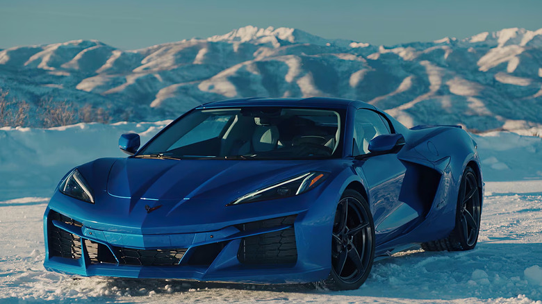 Blue Corvette E-ray parked on snowy mountain