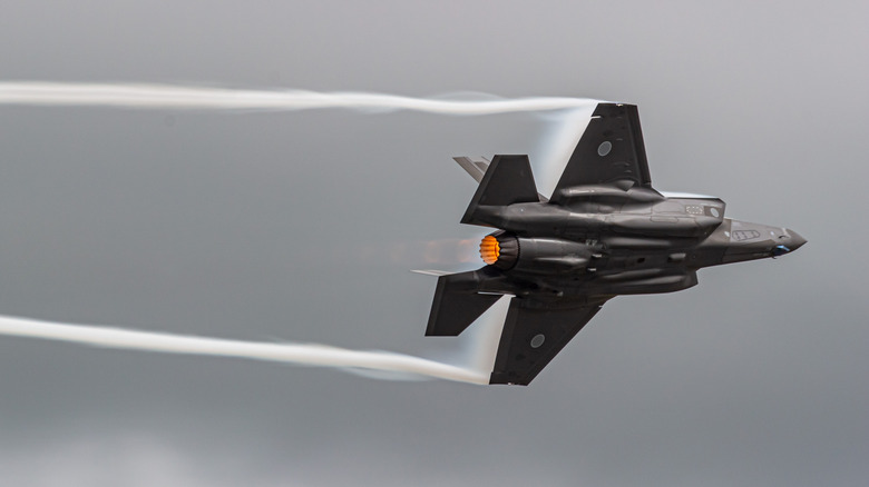 F-35 jet flying in gray sky