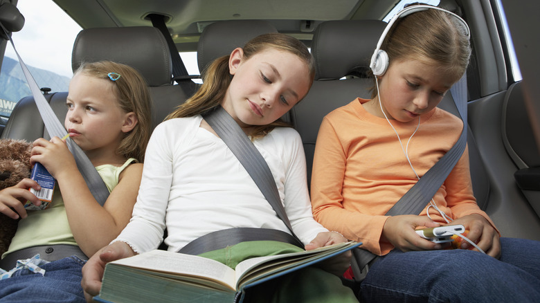 three girls sitting in back seat