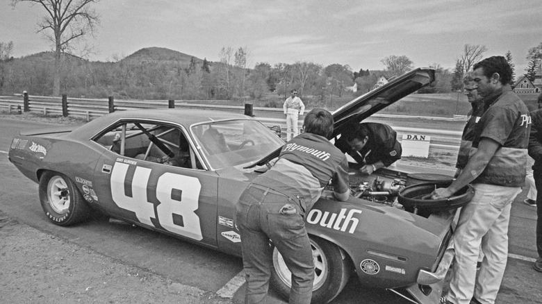 Mechanics working on a 1970 Plymouth Barracuda racecar