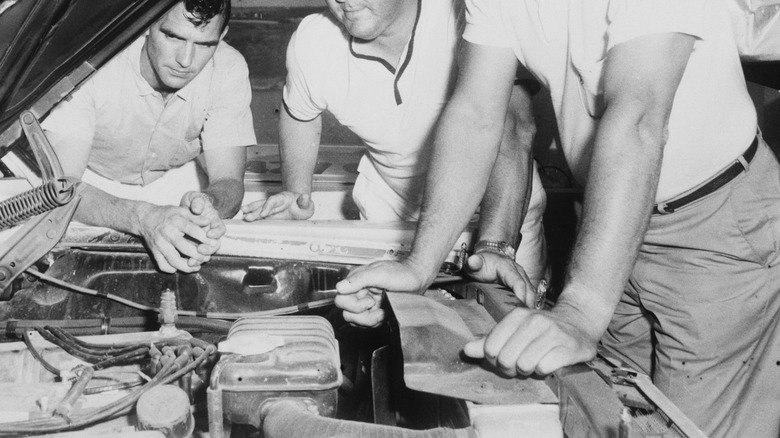 NASCAR mechanics looking at a Ford engine in 1965